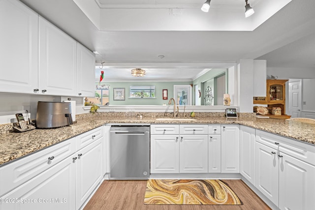 445 Park Ave, Satellite Beach, FL 32937 - kitchen with stainless steel dishwasher, light wood-type flooring, white cabinetry, light stone countertops, and crown molding