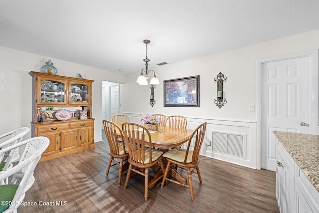 445 Park Ave, Satellite Beach, FL 32937 - dining room with dark wood-style floors and a wainscoted wall