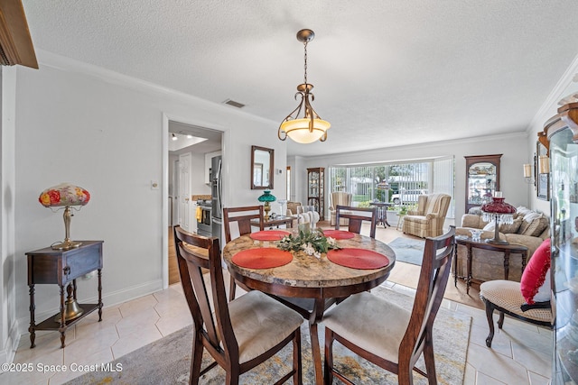 445 Park Ave, Satellite Beach, FL 32937 - dining area with a textured ceiling, ornamental molding, and light tile patterned flooring