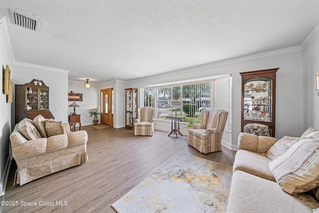 445 Park Ave, Satellite Beach, FL 32937 - living area with a textured ceiling, wood finished floors, and crown molding