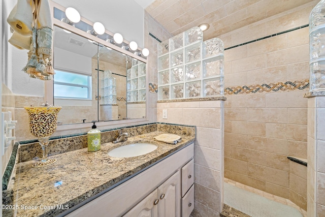 445 Park Ave, Satellite Beach, FL 32937 - full bath featuring walk in shower, vanity, and tile walls