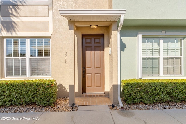 property entrance with stucco siding