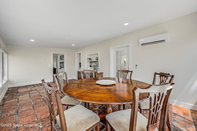 dining room featuring built in shelves, recessed lighting, baseboards, and a wall mounted AC