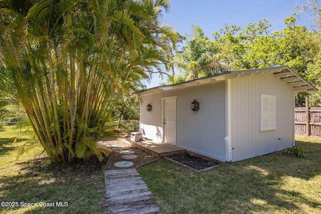 view of outdoor structure with an outbuilding and fence