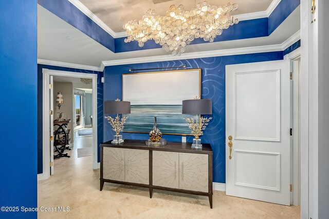 601 N Swim Club Dr Pha, Pha, Indian River Shores, FL 32963 - hallway featuring an inviting chandelier, a raised ceiling, and ornamental molding