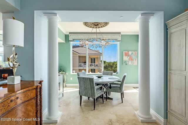 601 N Swim Club Dr Pha, Pha, Indian River Shores, FL 32963 - dining room with decorative columns, an inviting chandelier, crown molding, and baseboards