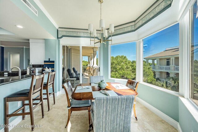 601 N Swim Club Dr Pha, Pha, Indian River Shores, FL 32963 - dining area featuring baseboards, crown molding, visible vents, and a notable chandelier