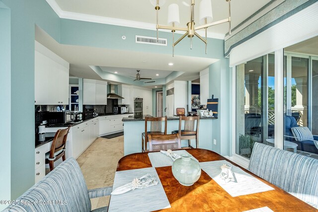601 N Swim Club Dr Pha, Pha, Indian River Shores, FL 32963 - dining room featuring a raised ceiling, ceiling fan with notable chandelier, visible vents, ornamental molding, and recessed lighting