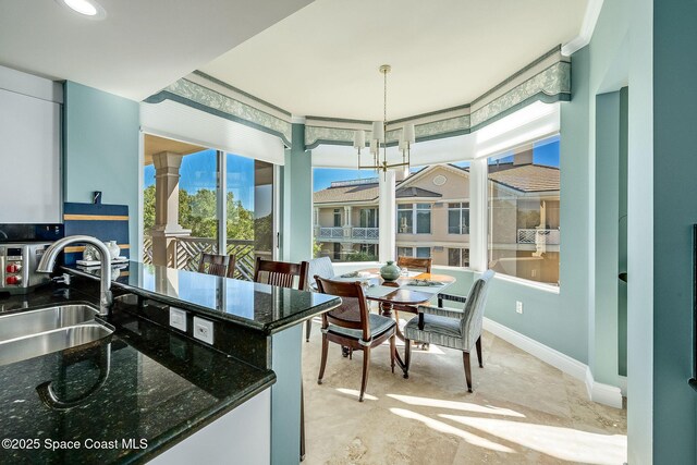 601 N Swim Club Dr Pha, Pha, Indian River Shores, FL 32963 - interior space with baseboards, pendant lighting, a sink, and dark stone counters