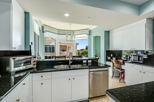 601 N Swim Club Dr Pha, Pha, Indian River Shores, FL 32963 - kitchen featuring white cabinetry, stainless steel appliances, a toaster, backsplash, and a sink