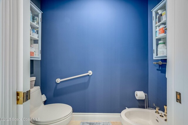 601 N Swim Club Dr Pha, Pha, Indian River Shores, FL 32963 - half bathroom featuring toilet, a sink, and baseboards