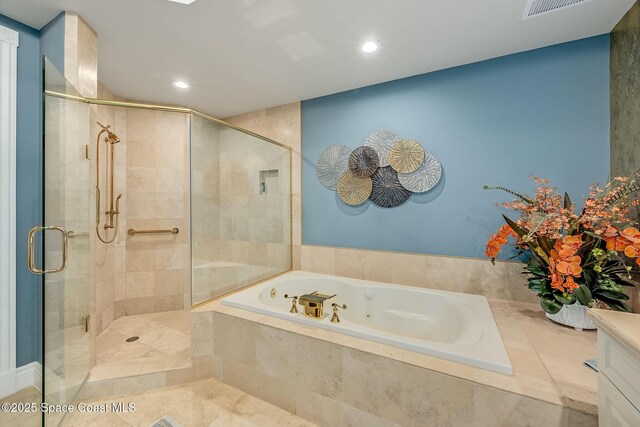 601 N Swim Club Dr Pha, Pha, Indian River Shores, FL 32963 - bathroom featuring a stall shower, visible vents, vanity, and a jetted tub