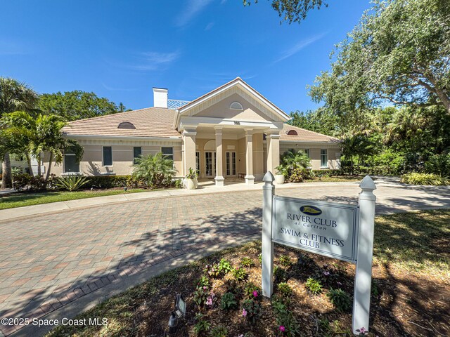 601 N Swim Club Dr Pha, Pha, Indian River Shores, FL 32963 - greek revival inspired property featuring stucco siding, a chimney, a tile roof, and french doors