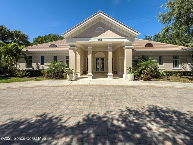 601 N Swim Club Dr Pha, Pha, Indian River Shores, FL 32963 - view of front facade featuring french doors, a tiled roof, and stucco siding
