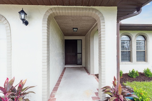 doorway to property with stucco siding