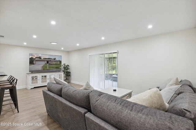 living area with recessed lighting, baseboards, visible vents, and light wood-type flooring