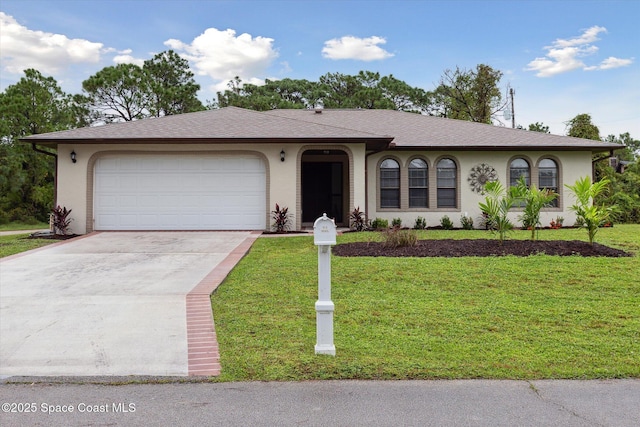 ranch-style home with driveway, a garage, a front lawn, and roof with shingles