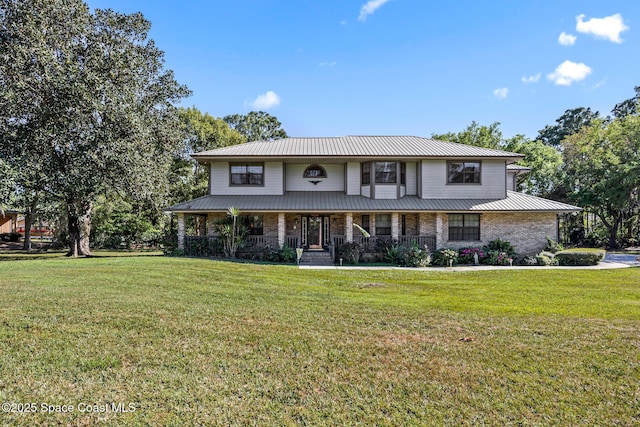 5425 James Ln, Mims, FL 32754 - view of front of home with a front lawn, metal roof, and covered porch