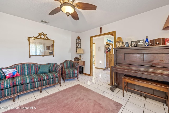 5425 James Ln, Mims, FL 32754 - tiled living area with baseboards, a textured ceiling, visible vents, and a ceiling fan
