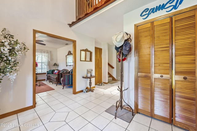 5425 James Ln, Mims, FL 32754 - corridor featuring light tile patterned flooring, baseboards, and stairway