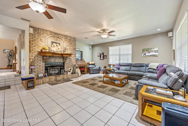 5425 James Ln, Mims, FL 32754 - living area with light tile patterned flooring, a brick fireplace, a textured ceiling, visible vents, and ceiling fan