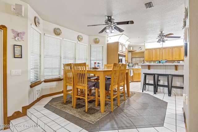 5425 James Ln, Mims, FL 32754 - dining space with a textured ceiling, visible vents, light tile patterned floors, and a ceiling fan