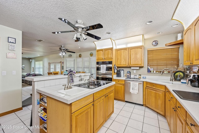 5425 James Ln, Mims, FL 32754 - kitchen featuring light tile patterned floors, stainless steel appliances, a sink, ceiling fan, and visible vents