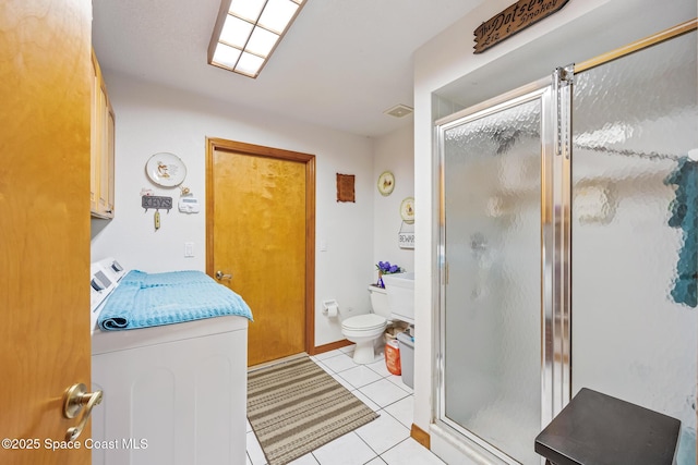 5425 James Ln, Mims, FL 32754 - full bathroom featuring a stall shower, tile patterned floors, toilet, baseboards, and independent washer and dryer