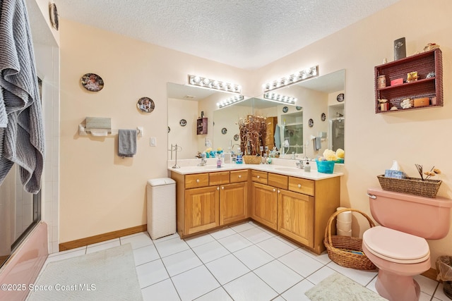 5425 James Ln, Mims, FL 32754 - bathroom with a textured ceiling, double vanity, toilet, tile patterned floors, and a sink