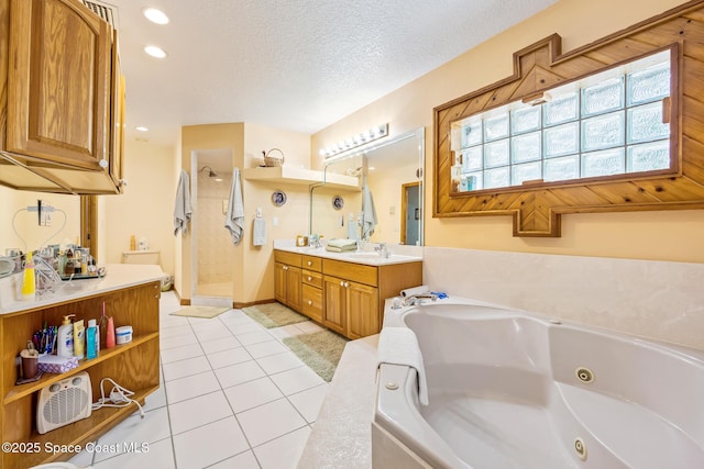 5425 James Ln, Mims, FL 32754 - bathroom with tile patterned floors, vanity, a jetted tub, a textured ceiling, and walk in shower
