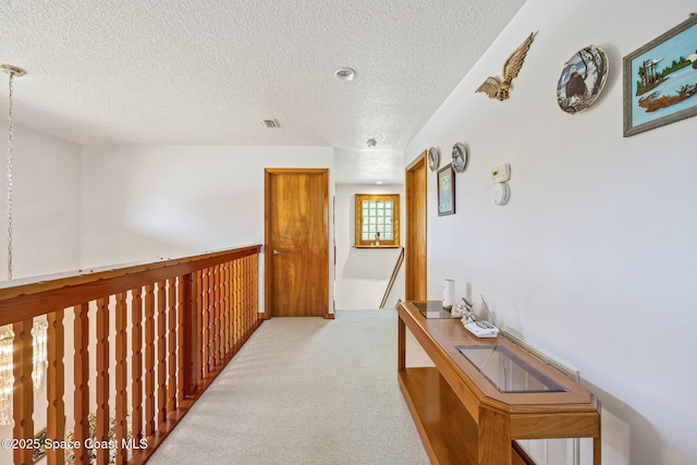 5425 James Ln, Mims, FL 32754 - hall featuring visible vents, an upstairs landing, carpet, and a textured ceiling