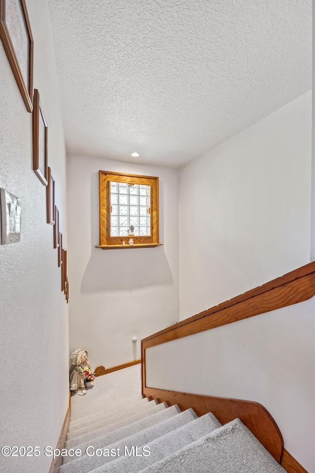 5425 James Ln, Mims, FL 32754 - stairway featuring baseboards and a textured ceiling