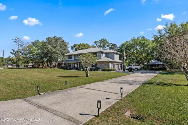 5425 James Ln, Mims, FL 32754 - view of front facade with a front yard and concrete driveway