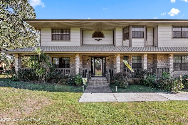 5425 James Ln, Mims, FL 32754 - view of front of property featuring a front lawn, a porch, and brick siding