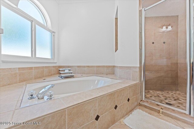 full bathroom featuring a stall shower and a bath