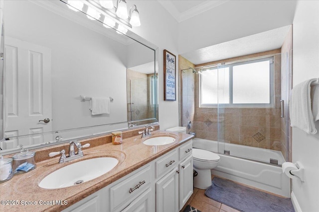 full bath with ornamental molding, a sink, toilet, and tile patterned flooring