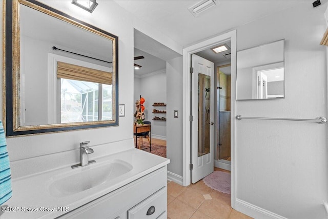 full bath featuring vanity, tile patterned flooring, walk in shower, baseboards, and visible vents
