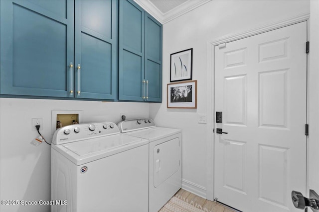 laundry room with washer and clothes dryer, light wood-style floors, cabinet space, and ornamental molding