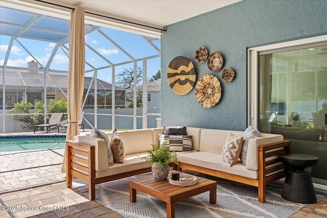sunroom / solarium featuring an outdoor living space and a swimming pool