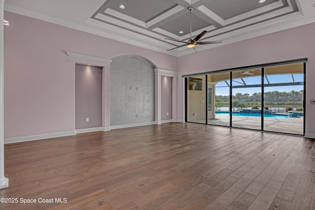 spare room with ornamental molding, baseboards, a ceiling fan, and wood finished floors