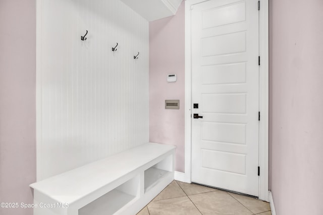 mudroom with light tile patterned floors and baseboards