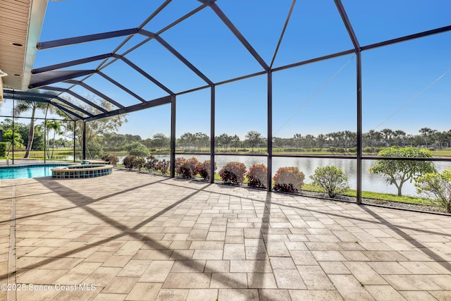 view of patio / terrace featuring a pool with connected hot tub, a water view, and glass enclosure