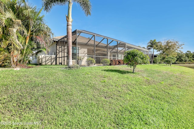view of yard with fence and glass enclosure