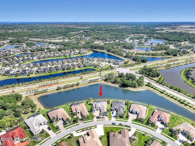 drone / aerial view with a water view and a residential view