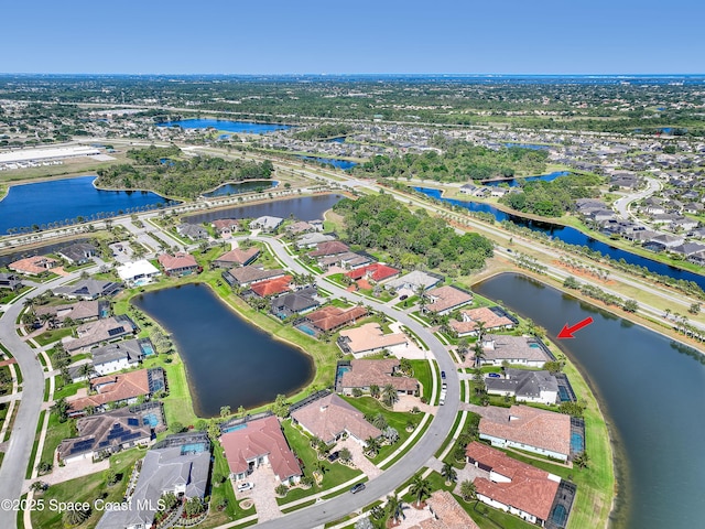 birds eye view of property with a water view and a residential view