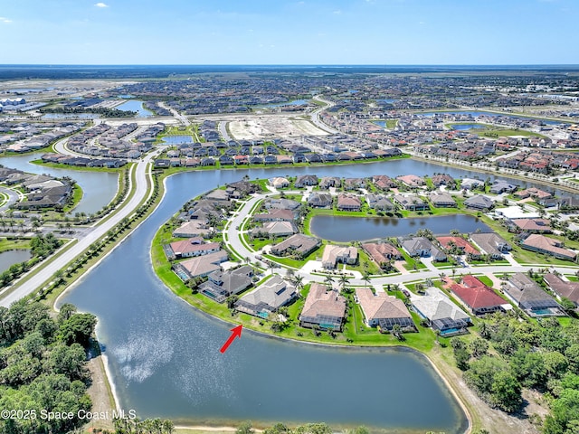 drone / aerial view featuring a residential view and a water view