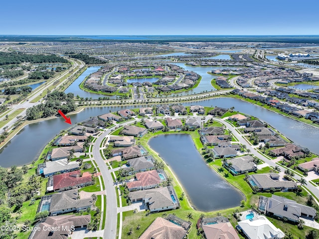 birds eye view of property featuring a residential view and a water view
