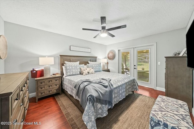 bedroom with a textured ceiling, access to exterior, french doors, and dark wood-type flooring