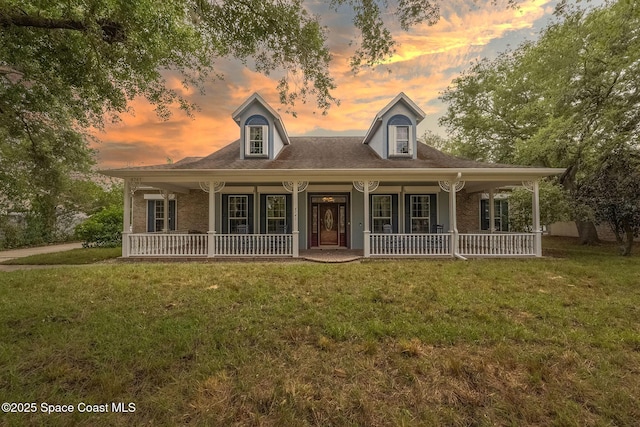 view of front of home featuring a porch and a yard
