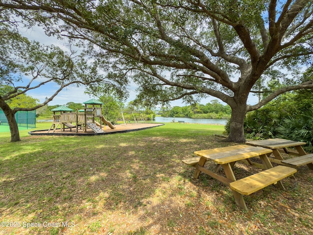 view of yard with playground community and a water view